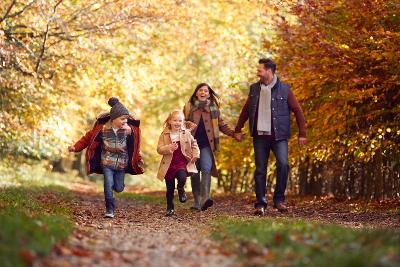 Family walking in the woods in autumn