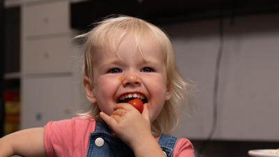 Little girl eating a strawberry