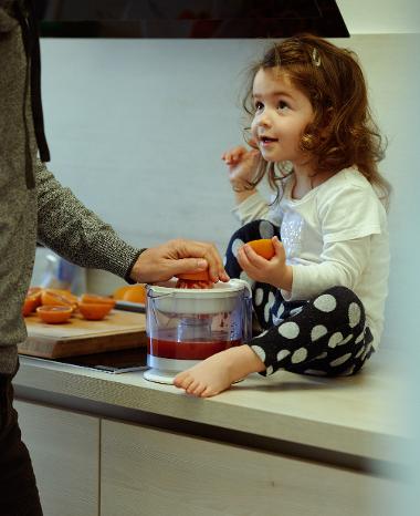 Little girl sitting on a kitchen bench