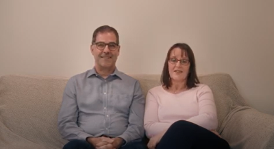 Foster carers Julia and Mark on a sofa