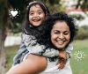 Woman and girl playing in field representing NHS worker who fosters