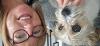 Sibling foster carer Ann has short hair and glasses, also pictured is her white jack russell, Lola
