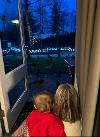 Foster carer and baby look at Christmas lights