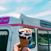 ice cream cone with van in background